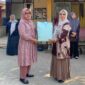 Kepala Sekolah SDN I Poyowa Besar Fatmiyati Makalalag SPd saat menyerahkan cenderamata perpisahan kepada Ibu Rosdaita Marada. Foto:Gnews86
